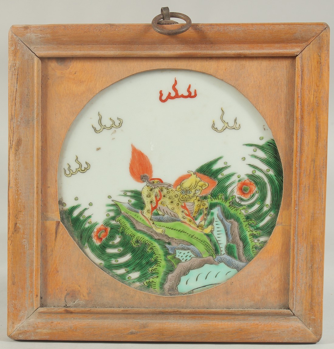 A CHINESE FAMILLE VERTE PORCELAIN PLAQUE, inset within a wooden framed, depicting a kylin, 24cm