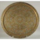 A LARGE ISLAMIC SILVER AND COPPER INLAID BRASS CIRCULAR TRAY, with panels of calligraphy and