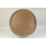 A LARGE ENGRAVED COPPER TRAY, with animals and calligraphy, 56cm diameter.
