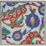 A LARGE IZNIK STYLE GLAZED POTTERY TILE, painted with foliate decoration, 28cm square.