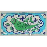 A FINE EARLY 19TH CENTURY NORTH INDIAN MULTAN GLAZED POTTERY TILE, painted with a green parrot, 30.