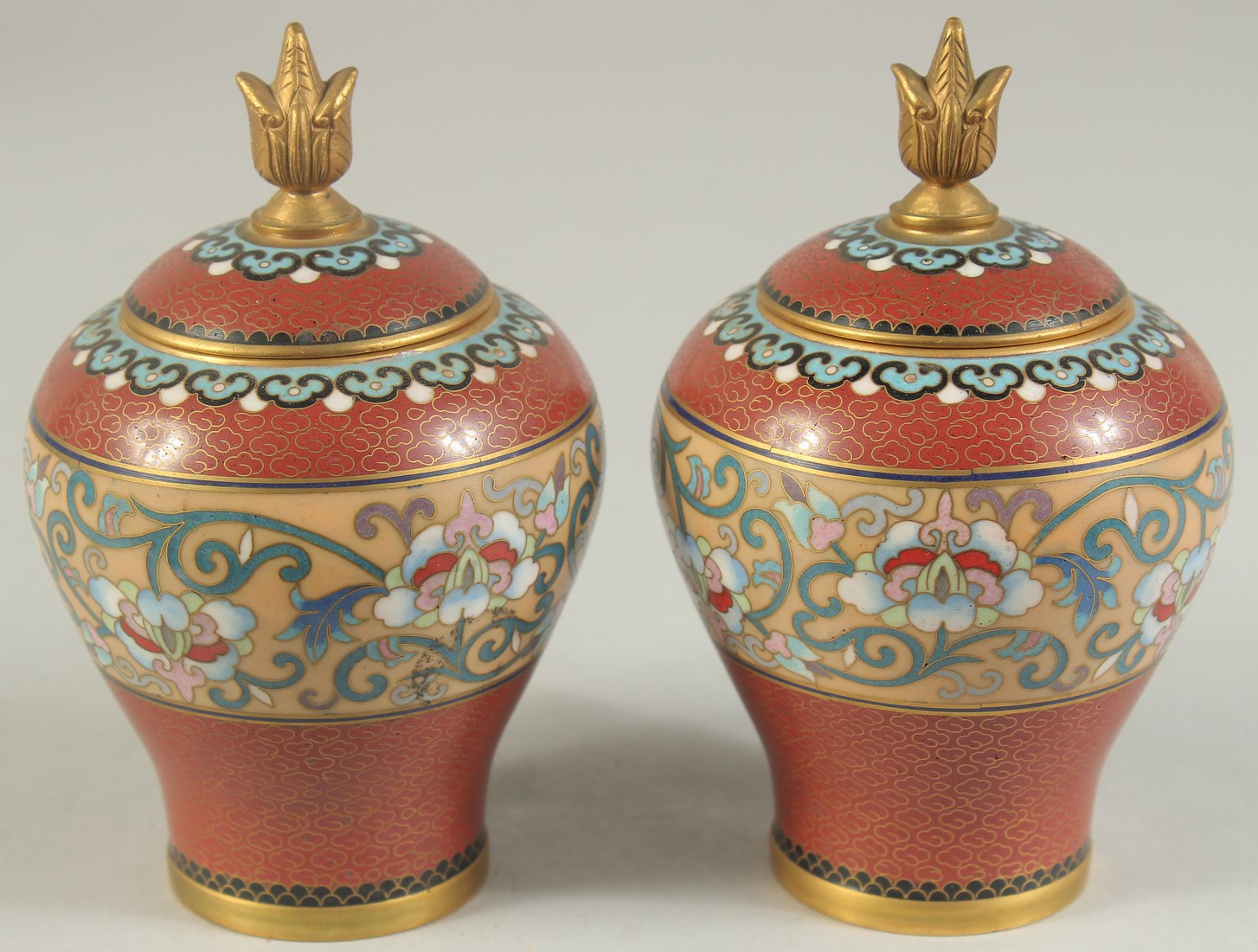 A PAIR OF MID 20TH CENTURY CHINESE CLOISONNE LIDDED JARS, each with a central band of foliate