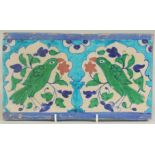 A FINE 19TH CENTURY NORTH INDIAN MULTAN GLAZED POTTERY TILE, depicting two green parrots within