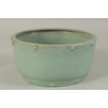A CHINESE CELADON RU WARE BOWL, the rims with raised bosses, 19cm diameter.