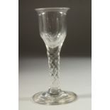 A LARGE 18TH CENTURY ENGLISH GLASS with faceted cut stem. 5.75ins high.