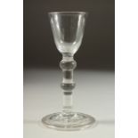 AN 18TH CENTURY ENGLISH WINE GLASS with inverted bowl with two knops to the stem.