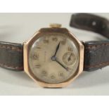 A LADIES VINTAGE GOLD ROLEX WRIST WATCH with leather strap.