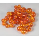 A GOOD AMBER GRADUATED BEAD NECKLACE, 23ins long, 44 beads. 50gms.