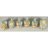A LARGE PAIR OF MEISSEN PORCELAIN FLOWER ENCRUSTED TREE DECORATIONS, 4.5ins long, and four small