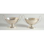 A GOOD PAIR OF GEORGE III SILVER OVAL TWO HANDLED SAUCE TUREENS with bead edge. London 1784.