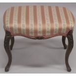 A VICTORIAN ROSEWOOD STOOL with padded top on curving legs. 1ft 11ins long.