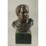 A SMALL BRONZE ROMAN BUST. 3.5ins on a marble base.
