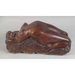 A VERY GOOD CARVED RED STONE NUDE RECLINING FIGURE. 18ins long.