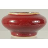 A CHINESE OX BLOOD GLAZE PORCELAIN BRUSH WASHER. 9cm diameter.