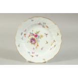 A MEISSEN PLATE white ground painted with flowers and insects. Cross sword mark in blue. 7.5ins