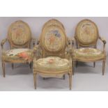 A GOOD SET OF FOUR LOUIS XVI 19TH CENTURY GILT ARMCHAIRS with oval backs and open arms, padded