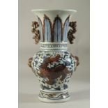 A CHINESE PORCELAIN BLUE AND RED VASE decorated with dragons. 14ins high.