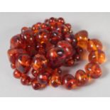 A GOOD SMALL AMBER BEAD NECKLACE of graduated beads. 24ins long, 62 beads, 35gms.
