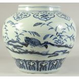 A LARGE CHINESE BLUE AND WHITE PORCELAIN JAR decorated with birds and flora. 30cm high.