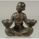 A JAPANESE BRONZE SEATED BOY. 2.5ins high.