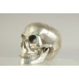 A SILVER PLATED SKULL with moving jaw. 4ins.