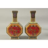 A PAIR OF CHINESE PORCELAIN OCTAGONAL VASES painted with birds. 10ins high.