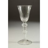 AN 18TH CENTURY ENGLISH WINE GLASS with inverted bell bowl and air twist stem, with a knop. 6ins