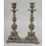 A GOOD PAIR OF BRONZE CANDLESTICKS with triangular cupid bases. 12ins high.