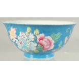 A CHINESE FAMILLE ROSE BLUE GROUND PORCELAIN BOWL decorated with flora. 15cm diameter.