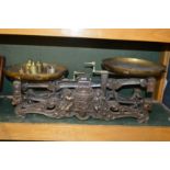 A VERY GOOD LARGE SET OF CAST IRON SCALES with brass pans and weights. 16ins long.