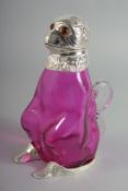 A SILVER PLATED RUBY GLASS CLARET JUG with glass eyes.