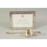 A SILVER TEA STRAINER, LONDON, 1904, together with a silver frame. Tea strainer: hallmarked.