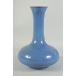 A CHINESE PORCELAIN BLUE BULBOUS VASE. 13ins high.