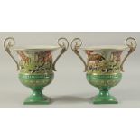 A PAIR OF SEVRES DESIGN GREEN GROUND, TWO HANDLED URN SHAPED HUNTING SCENES VASES. 11ins high.