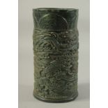A LARGE CHINESE CARVED JADE CIRCULAR BRUSH POT, carved with dragons. 10ins high.