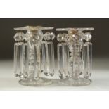 A GOOD PAIR OF REGENCY CUT GLASS LUSTRES with prism drops and circular bases. 5.5ins high.
