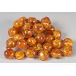 A GOOD SMALL AMBER BEAD NECKLACE of large beads, 32 beads, 24ins long. 80gms.