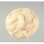 A CARVED BONE EROTIC BALL. 3.5cm.