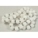 A STRING OF SIXTY WHITE BEADS.