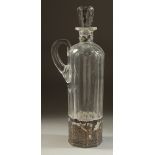 A DUTCH GLASS LIQUEUR DECANTER AND STOPPER with carrying handle and silver top and base. 11.5ins