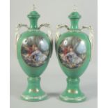 A PAIR OF GREEN GROUND SEVRES STYLES TWO HANDLED VASES AND COVERS with oval classical scenes. 1ft