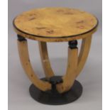 AN ART DECO STYLE BLONDWOOD CIRCULAR TABLE on curving supports. 1ft 10ins high x 2ft 11ins