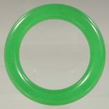A CHINESE APPLE GREEN BANGLE. 3ins diameter.