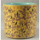A CHINESE PORCELAIN YELLOW GROUND BRUSH POT with birds and flowers. 7ins high.