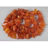 A GOOD FACETED AMBER BEAD NECKLACE, 100 beads, 30ins long, 122gms.