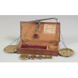 A BOX SET OF BRASS BALANCE SCALES AND WEIGHTS.