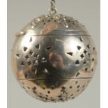 A SILVER GLOBULAR TEA INFUSER on a chain. 1.75ins diameter.