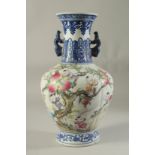 A CHINESE PORCELAIN VASE painted with children and peaches. 14ins high.
