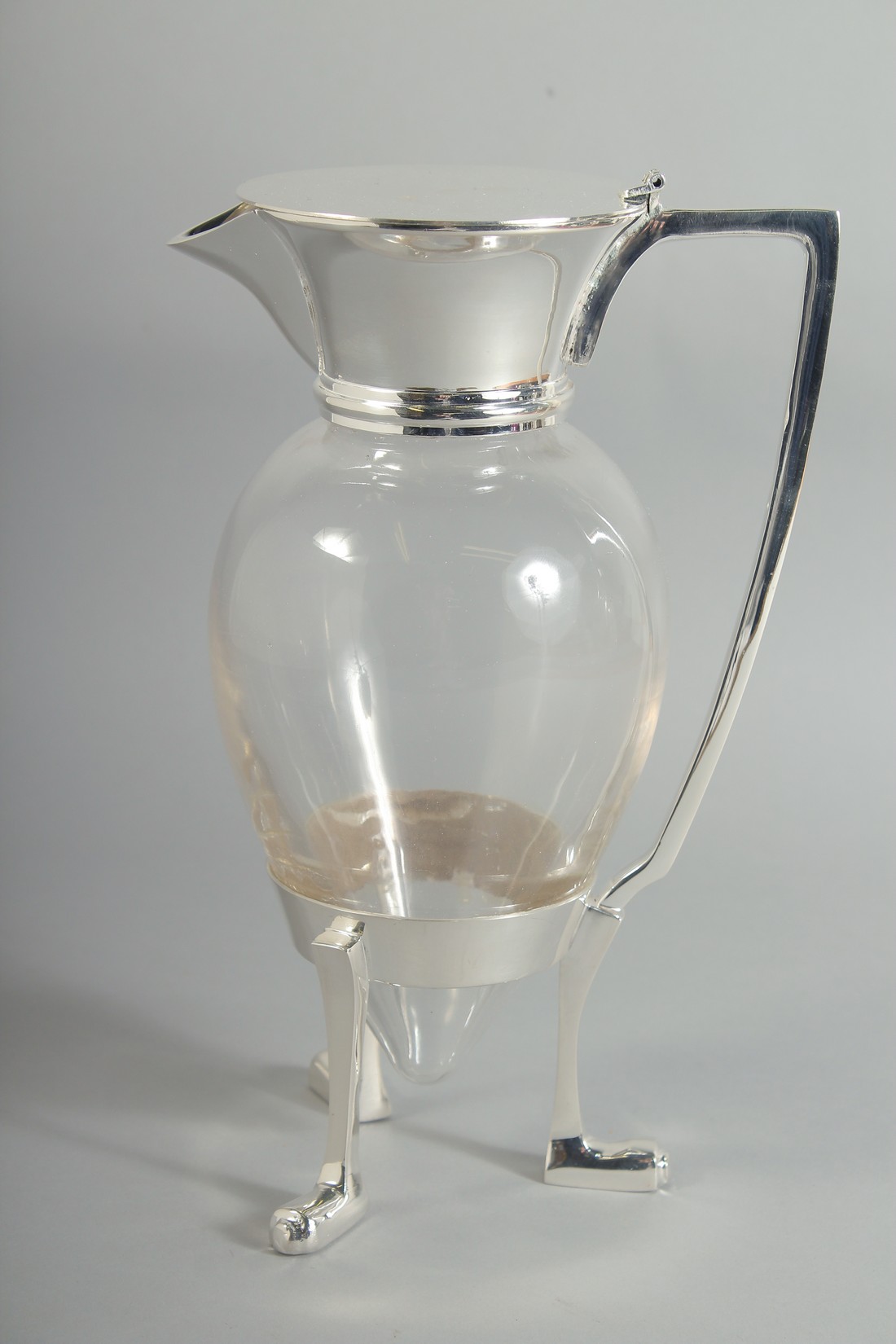 A CHRISTOPHER DRESSER STYLE SILVER PLATED, CROWS FOOT CLARET JUG. 10ins high.