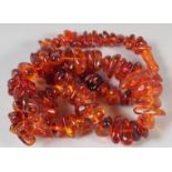 A GOOD GRADUATED AMBER BEAD NECKLACE, 100 beads, 26ins long, 89gms.